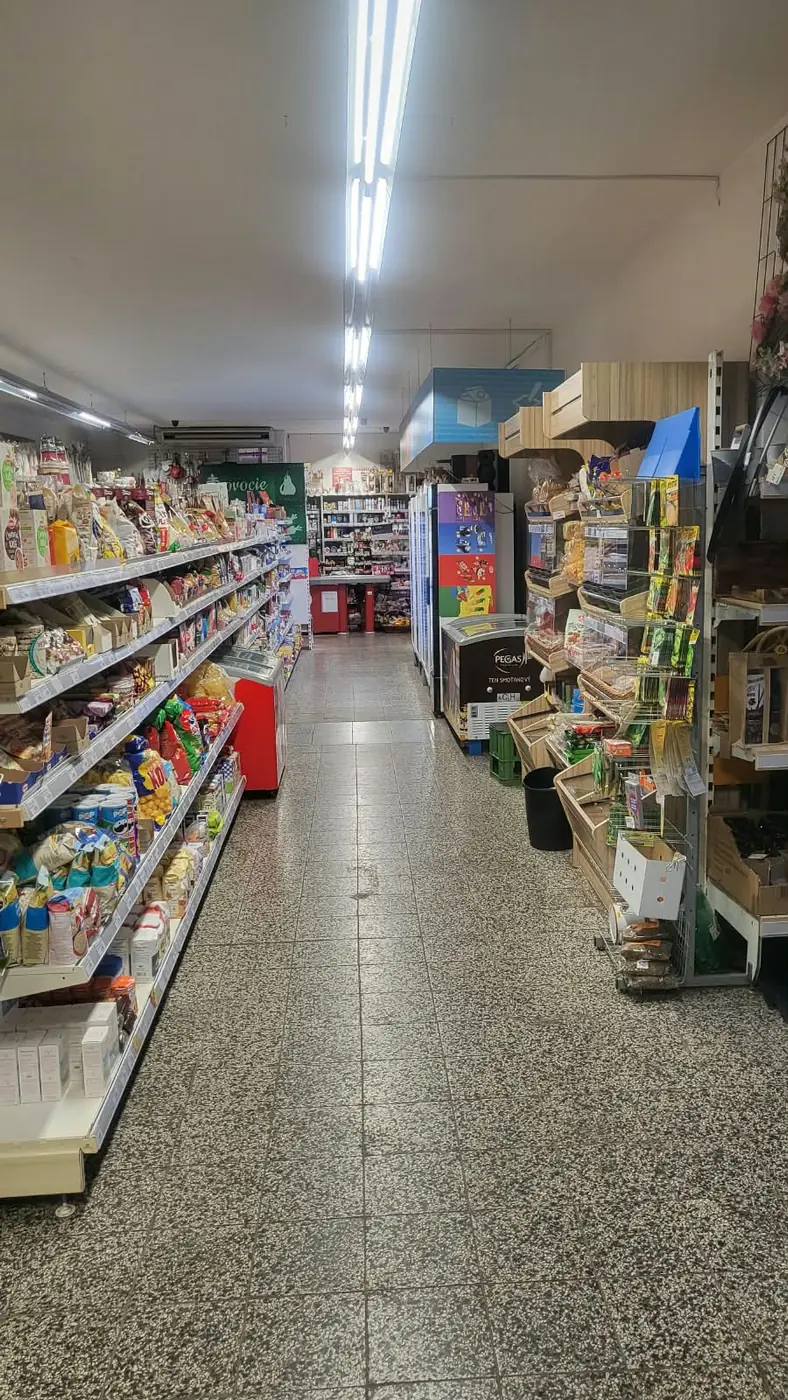 The main aisle of a shop selling non-perishable food and seasonal goods