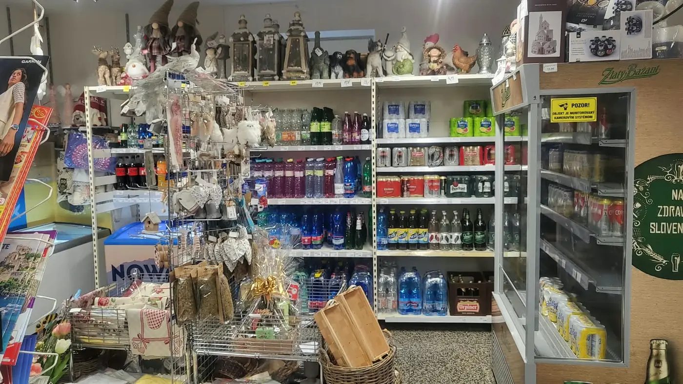 Shelves stocked with mineral water, cordials and beer, with decorations on top